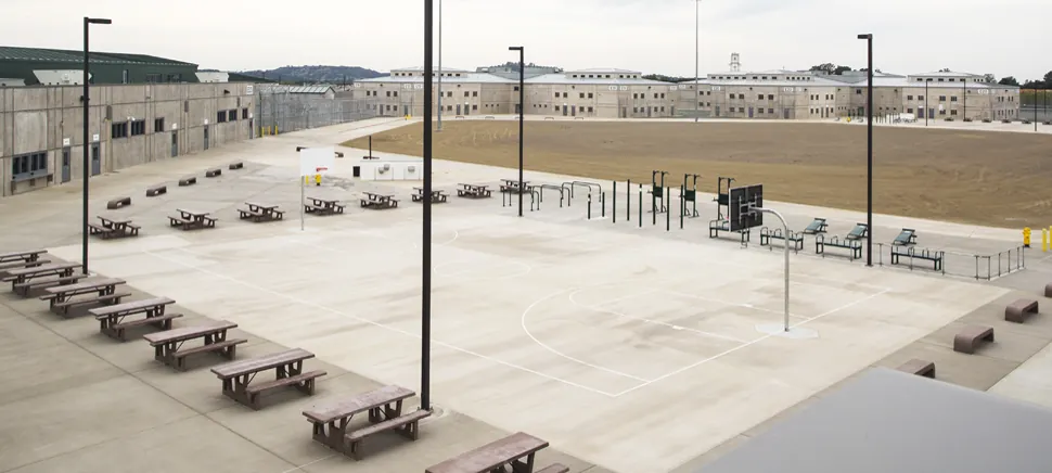 Mule Creek State Prison recreation yard and housing buildings in daylight