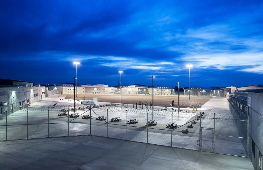 Mule Creek State Prison recreation yard and housing buildings at night